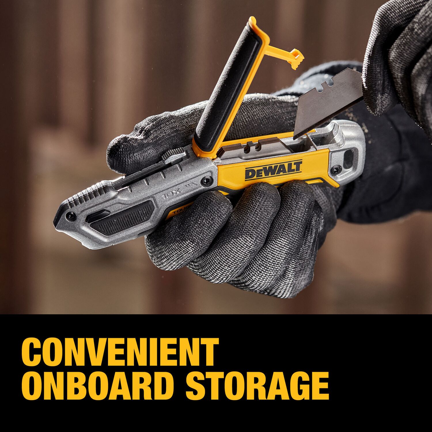 Contractor accessing the onboard blade storage compartment of the DeWalt DWHT10999 TOUGHSERIES utility knife while inserting a spare blade.