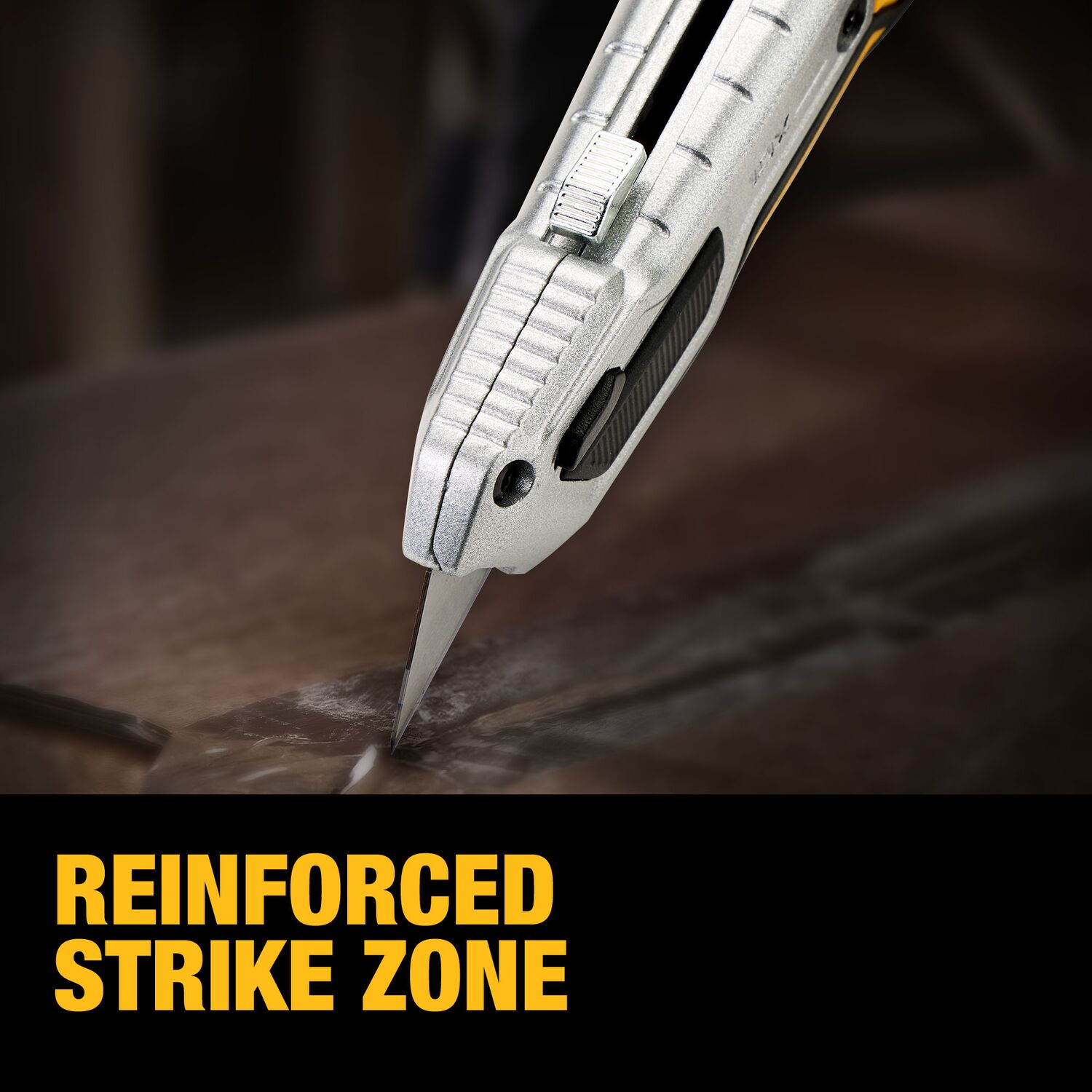 Close-up of the DeWalt DWHT10999 TOUGHSERIES utility knife showing the reinforced strike zone and extended blade making a cut on a work surface.
