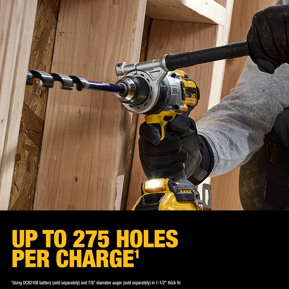 Contractor drilling a large hole through wood framing with a DEWALT cordless drill equipped with a DEWALT DCB2108 20V MAX XR Powerpack 8Ah battery, showing an auger bit in operation and on-image text reading “Up to 275 holes per charge,” in an active construction setting.