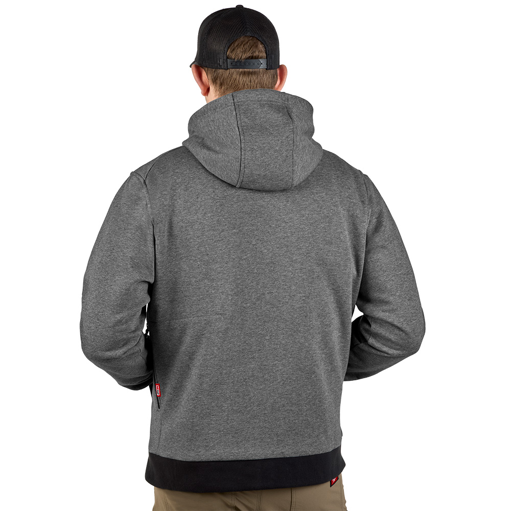 Rear view of a model wearing a grey Milwaukee M12 heated hoodie with hood up, showing full back coverage, athletic fit, and clean exterior profile designed for layering and cold-weather jobsite comfort