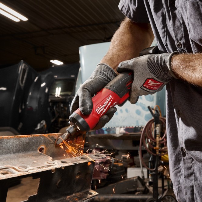 Milwaukee M12™ FUEL™ 1/4" Straight Die Grinder grinding metal on a vehicle frame, demonstrating cordless performance for fabrication, repair, and metalworking applications.