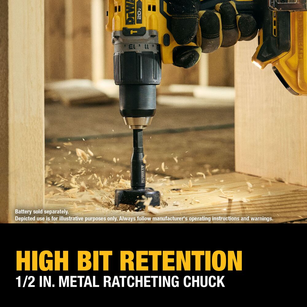 Lifestyle image of the DEWALT 20V MAX XR brushless 1/2 in. hammer drill boring a large hole in dimensional lumber with a self-feed wood bit. On-image callout highlights the 1/2 in. metal ratcheting chuck for high bit retention.