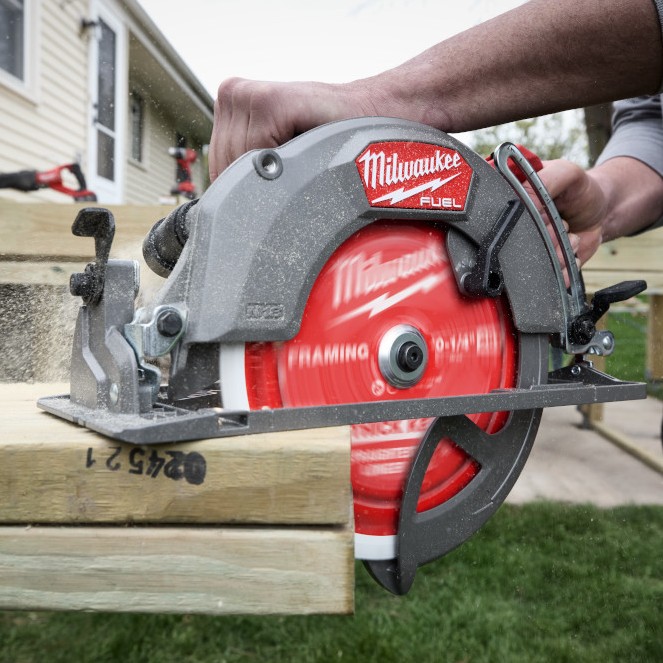 Carpenter using a Milwaukee M18 FUEL 10-1/4" rear-handle circular saw to cut thick dimensional lumber outdoors.