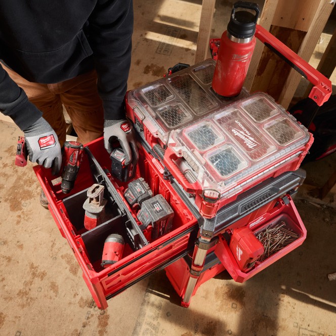 MILWAUKEE PACKOUT Single-Drawer Tool Box shown open in a mobile jobsite storage stack, with cordless tools, batteries, and hand tools organized using the adjustable dividers.